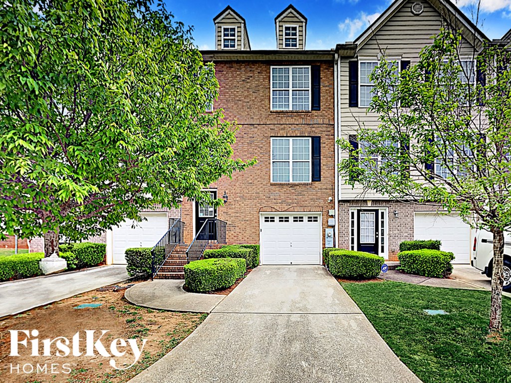 A house with a tree in front of it.