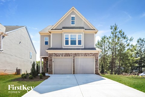 a house with a garage and a driveway in front of it