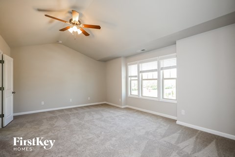 the master bedroom is spacious and has a ceiling fan