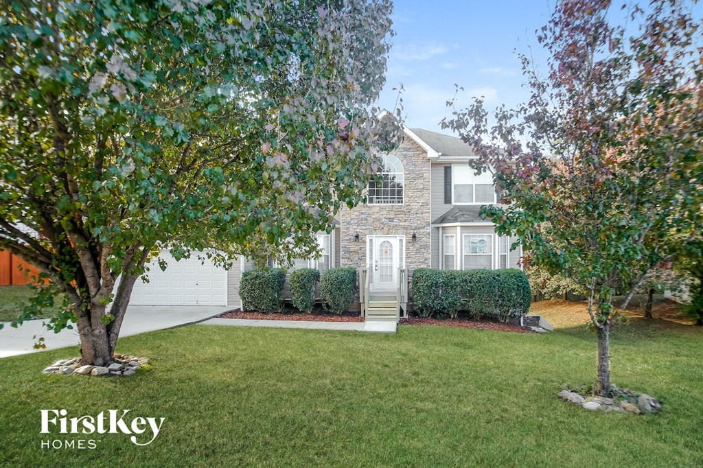 a large lawn in front of a house with a white door