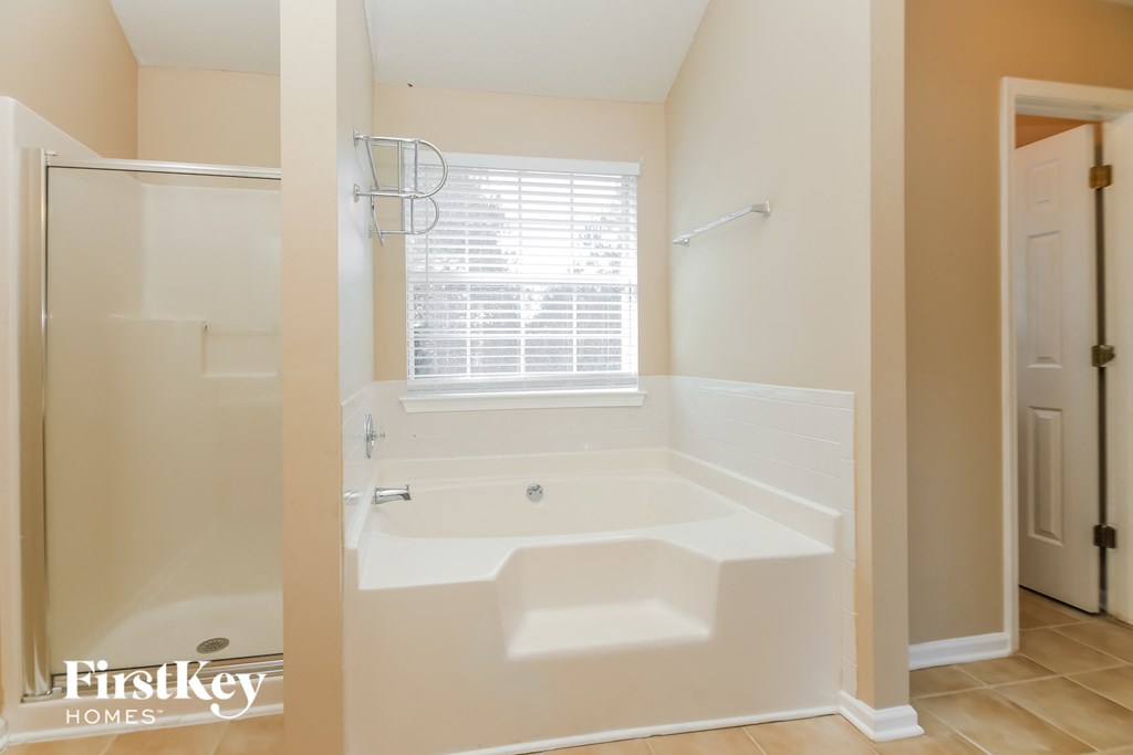 a small bathroom with a tub and a shower