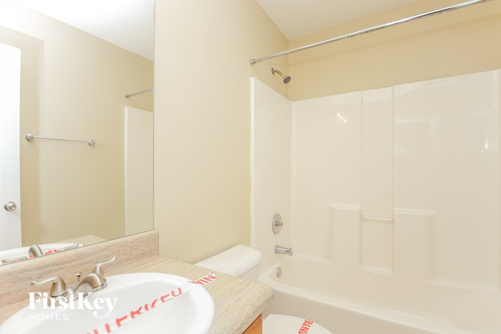 a bathroom with a sink and a shower and a bath tub