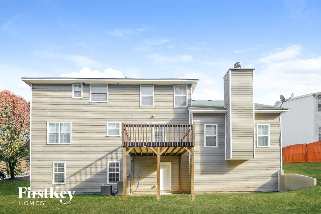 the back of a house with a deck and a porch