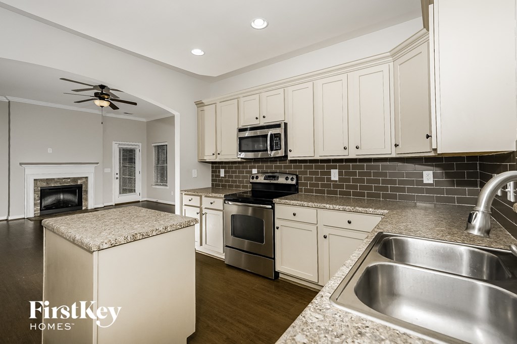 A kitchen with a stove, oven, and microwave.
