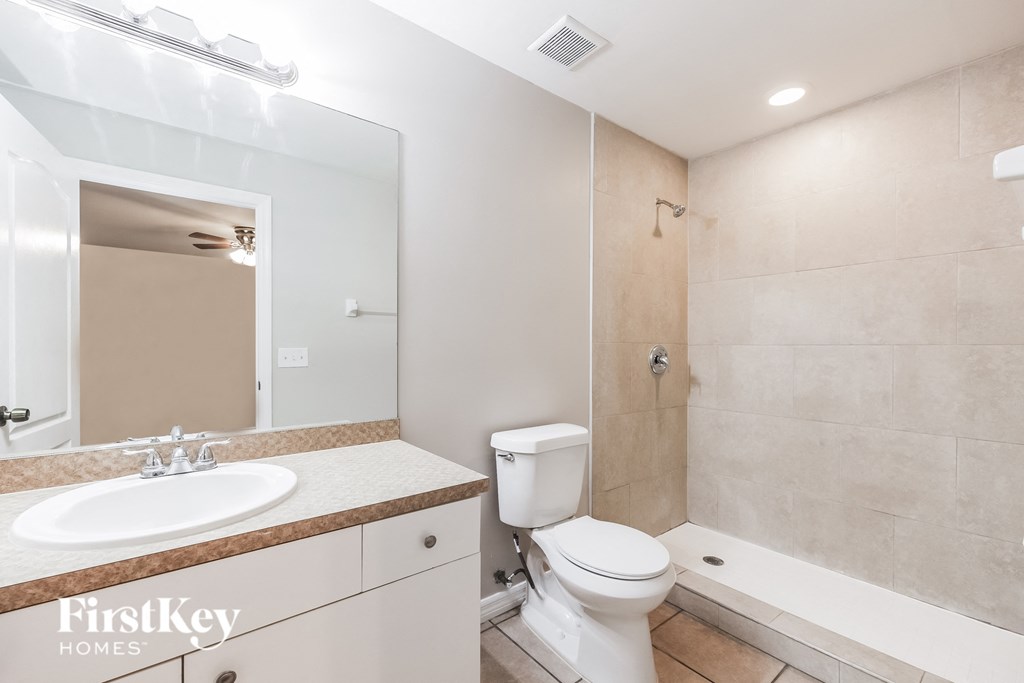 a bathroom with a toilet and a sink and a tub