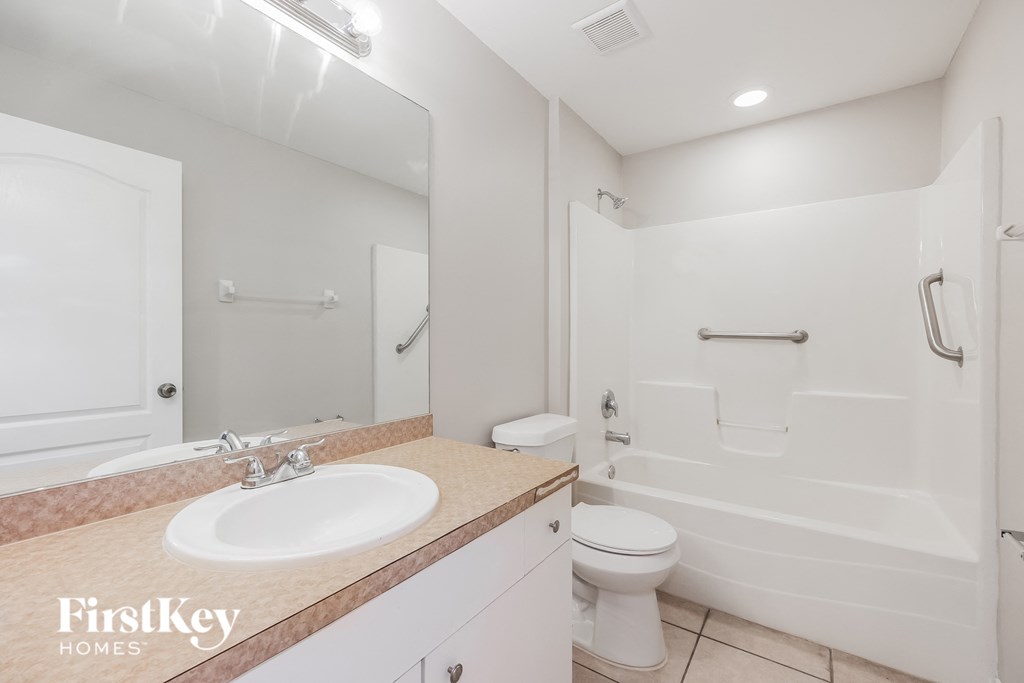 a bathroom with a sink and a toilet and a shower