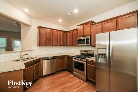 a kitchen with stainless steel appliances and wooden cabinets