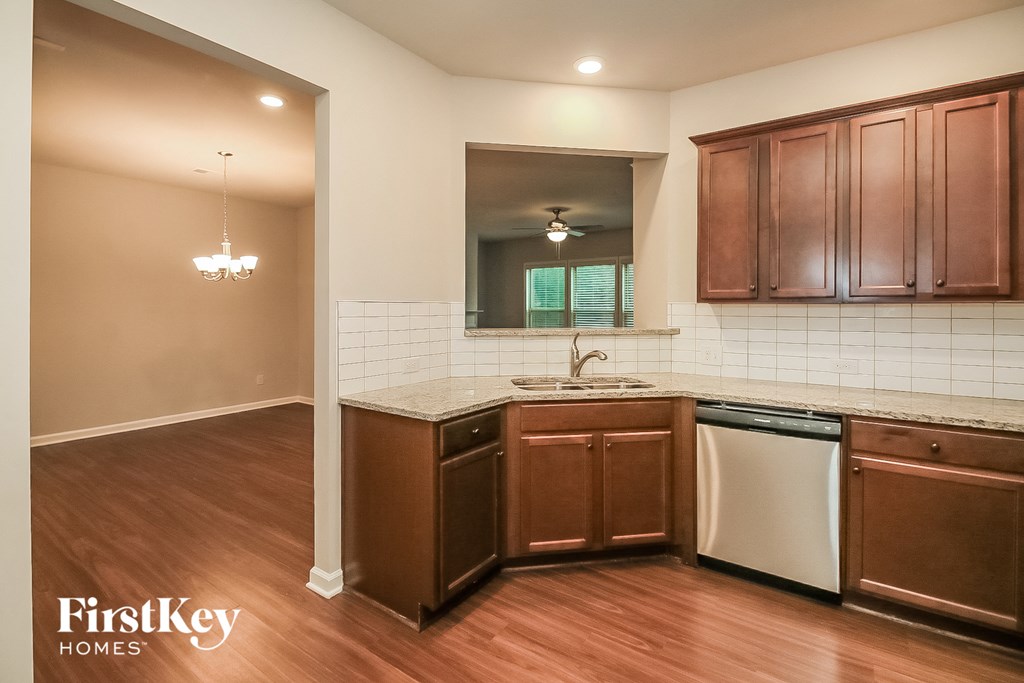 a kitchen with wooden cabinets and a sink and a dishwasher