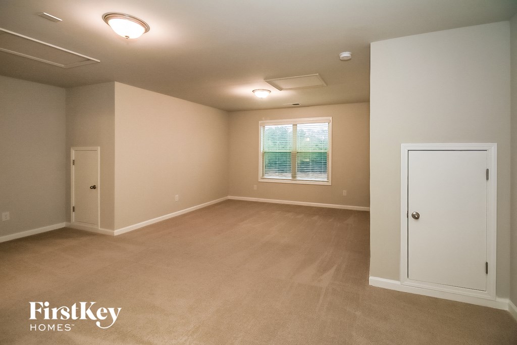 an empty room with a door and a window