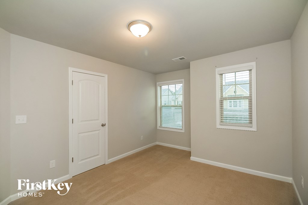 a bedroom with a white door and a window