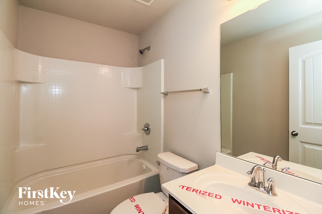 a bathroom with a sink toilet and a bath tub