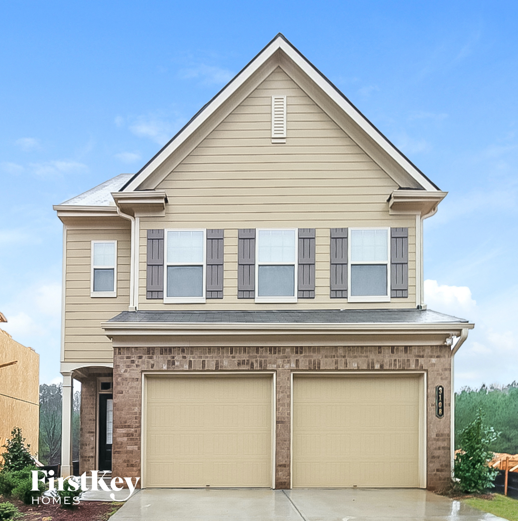 the front view of a house with two garage doors