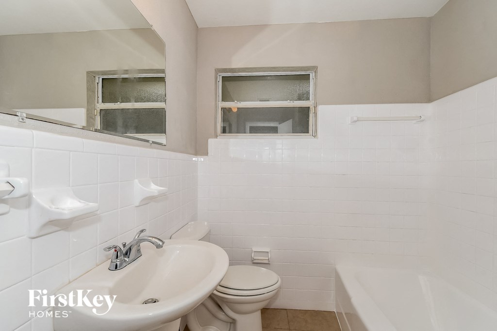 a bathroom with a sink and a toilet and a tub