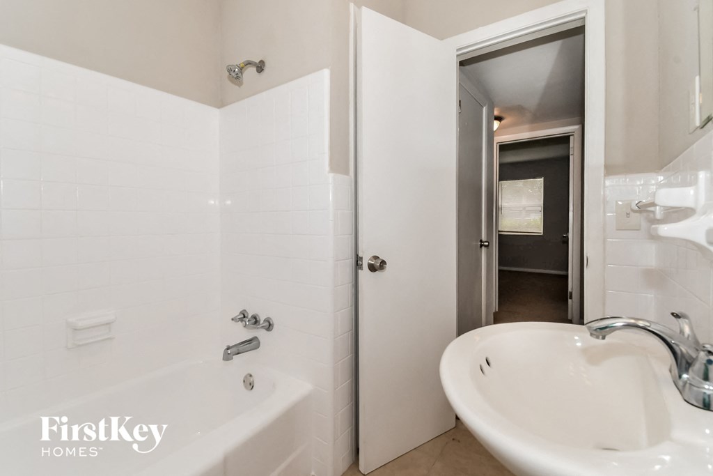 a bathroom with a sink and a tub and a shower
