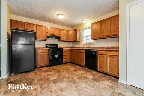 a kitchen with black appliances and wooden cabinets