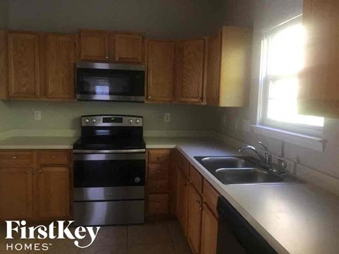 A kitchen with wooden cabinets and stainless steel appliances.