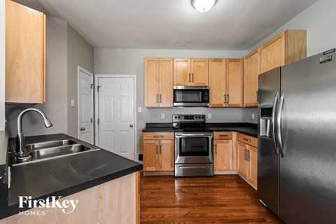 a kitchen with wooden cabinets and stainless steel appliances