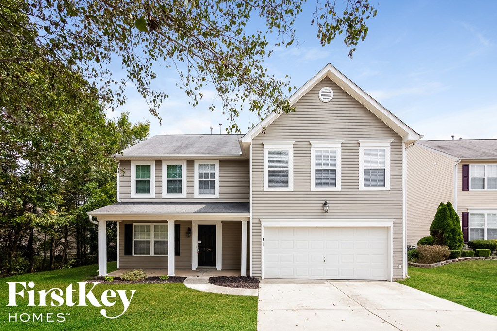 a beige house with a white garage door