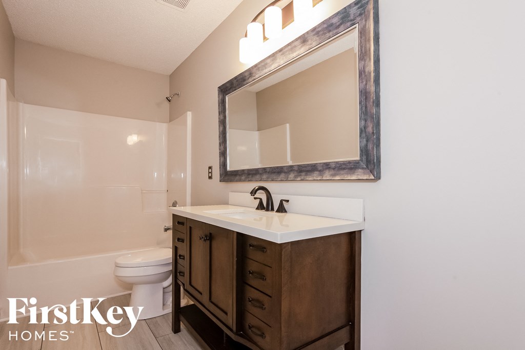 a bathroom with a sink and a toilet and a mirror