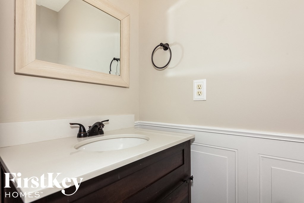 a small bathroom with a sink and a mirror