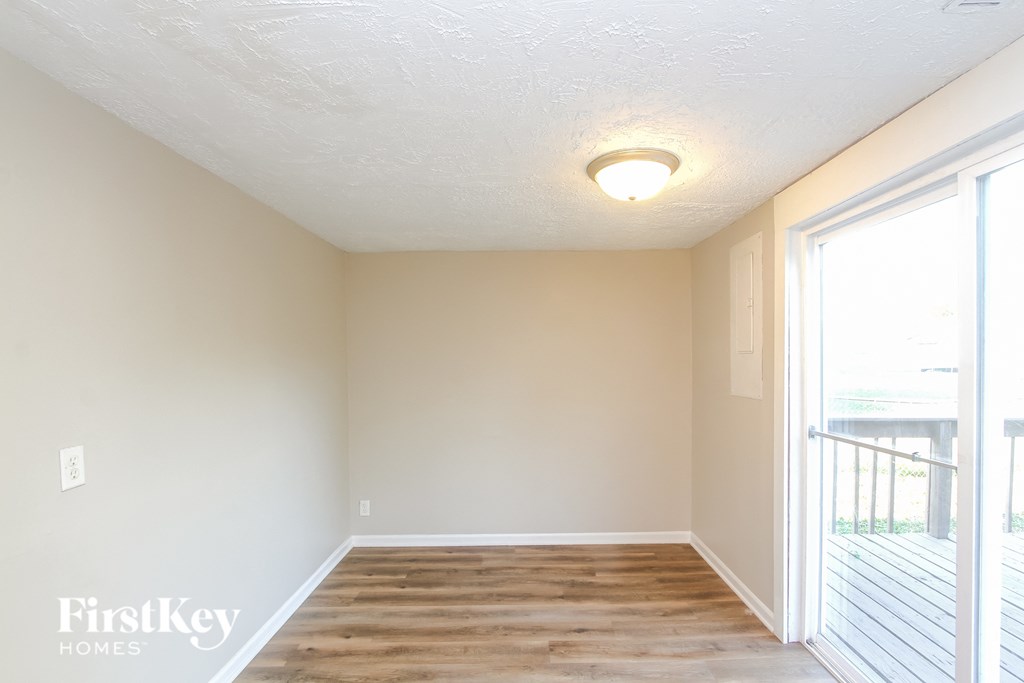 A room with wooden floors and a sliding glass door.