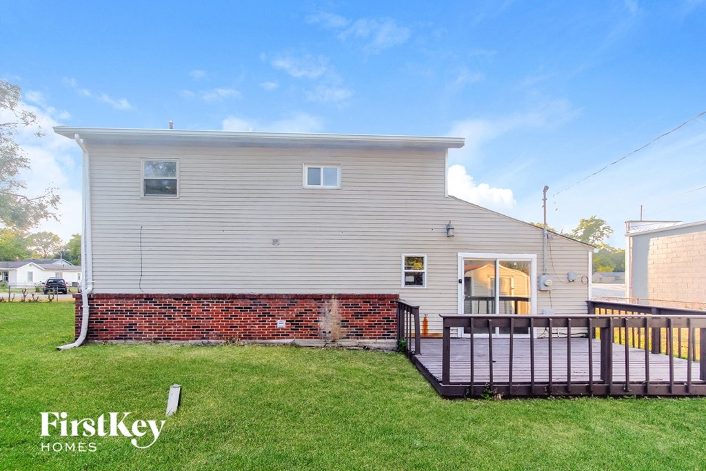 A house with a brick wall and a porch.