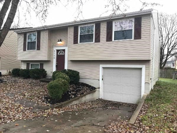 a tan house with a white garage door