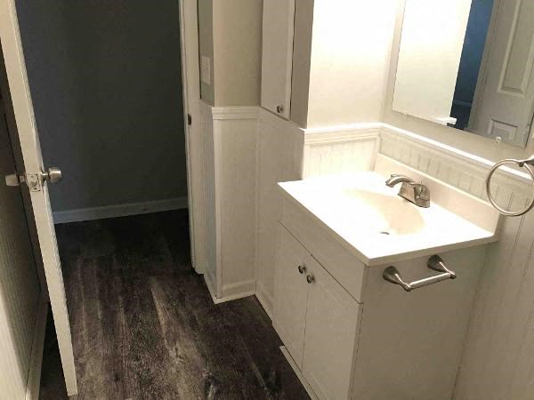 a bathroom with a white sink and a mirror