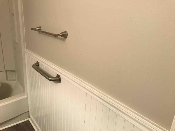 a bathroom door with a handle on the wall