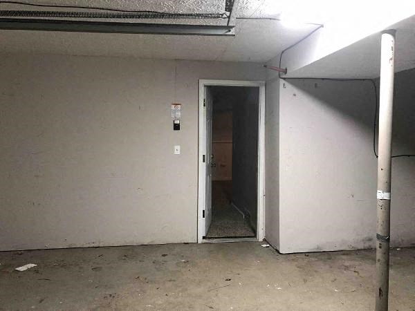 an empty room with a door to a hallway