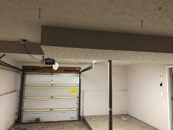 a garage with a white wall and a garage door