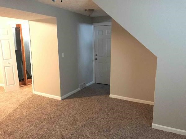 an empty room with a door and a closet
