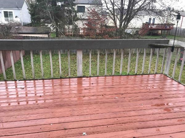 a wooden deck with a wooden fence