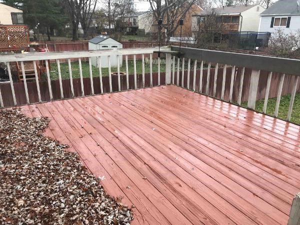 a wooden deck on top of a backyard