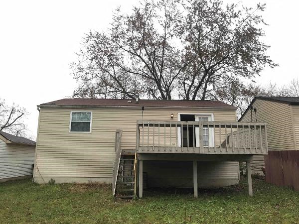 a house with a deck and a ladder
