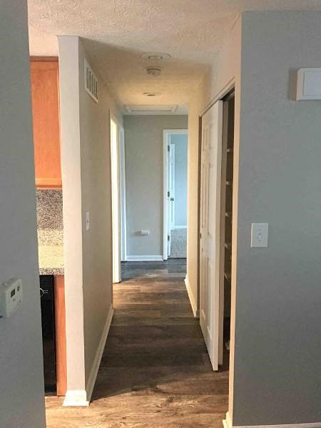 a hallway with a wood floor in a house