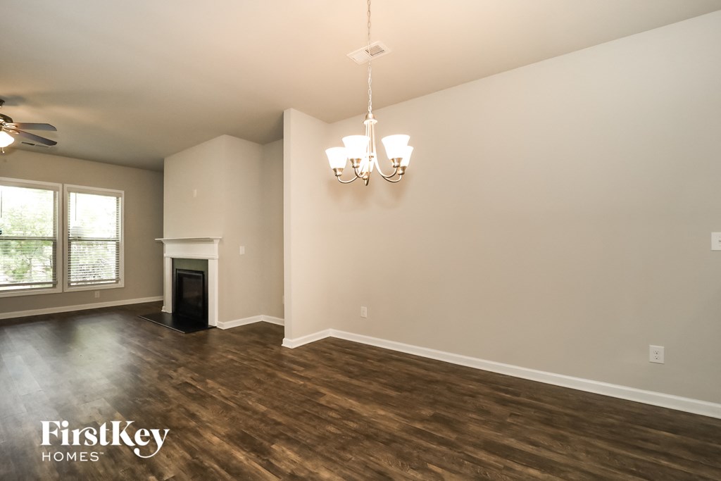 the living room of an empty house with a fireplace