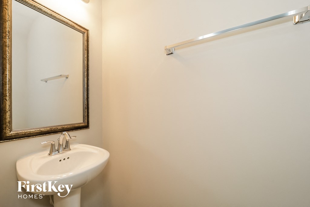 a small bathroom with a sink and a mirror