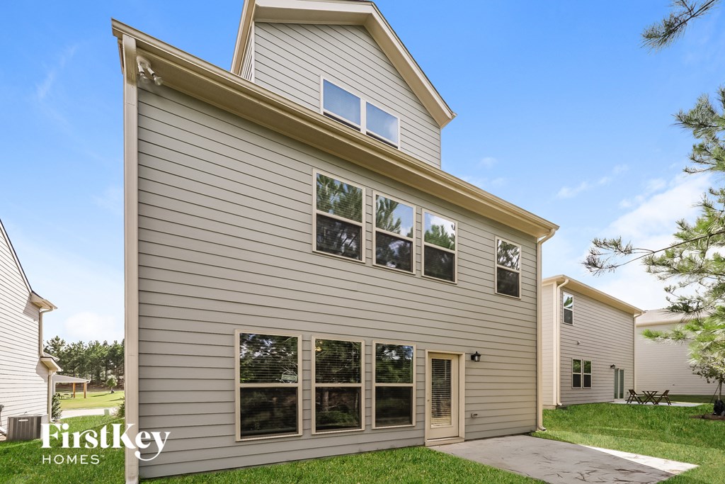 the outside of a house with a sidewalk and grass