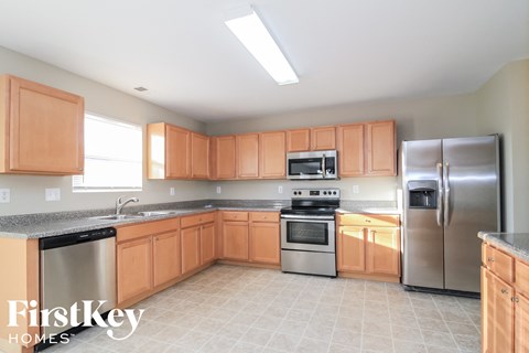 A kitchen with wooden cabinets and stainless steel appliances.