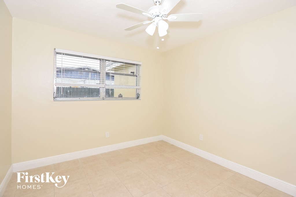 a living room with a ceiling fan and a window