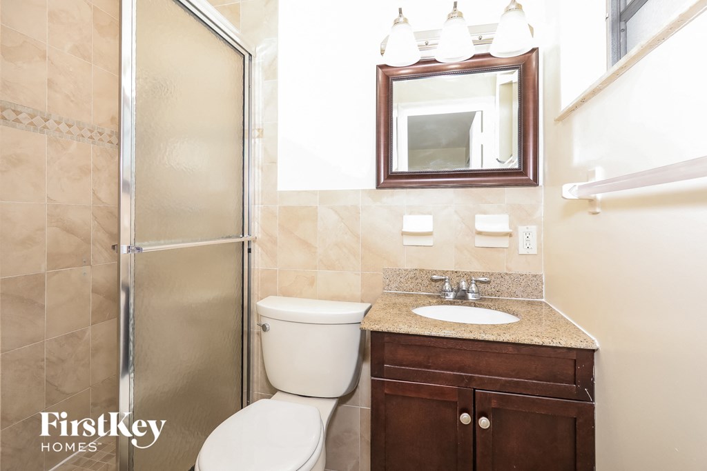 a small bathroom with a shower toilet and sink