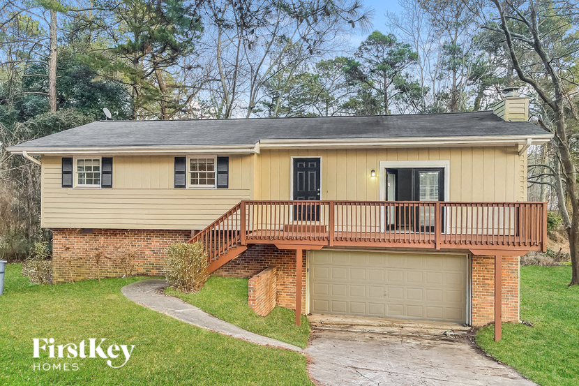 A house with a garage and a balcony is for sale.