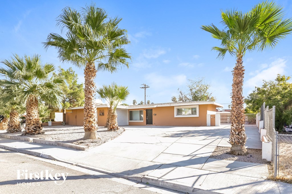 a house with palm trees in front of it