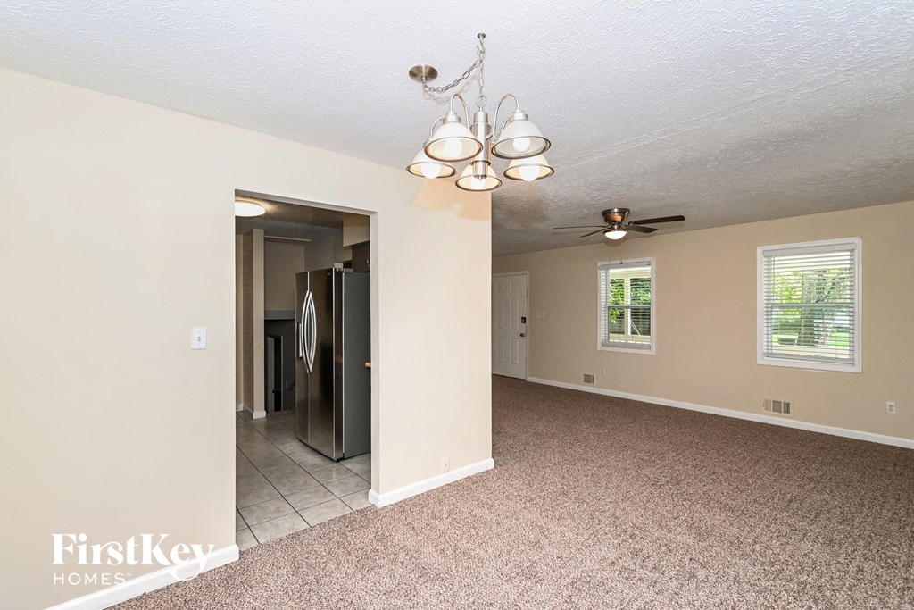 the living room and dining room of an empty house