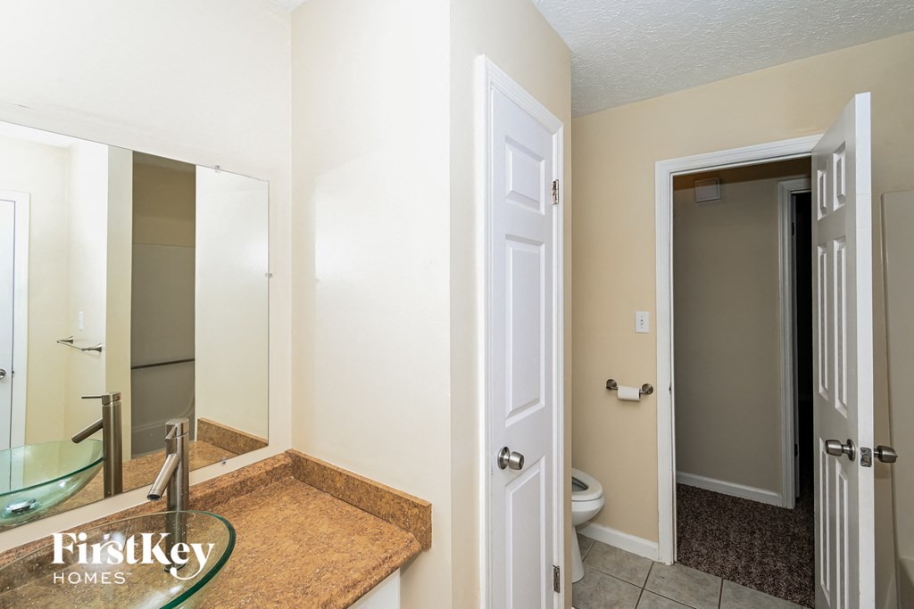 a bathroom with a sink and a mirror and a toilet