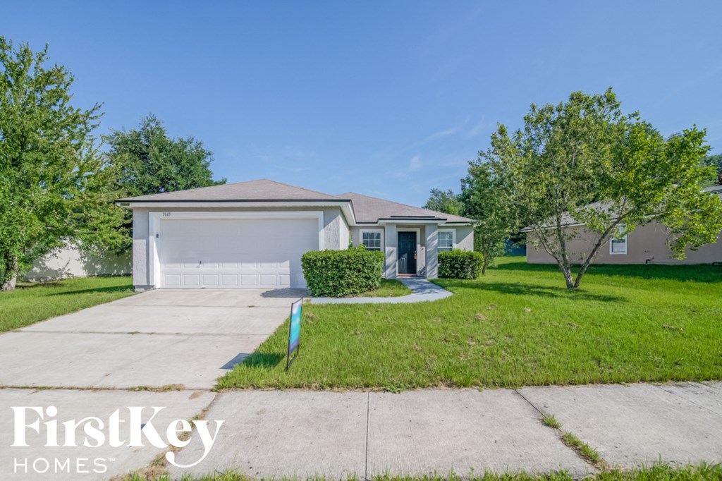 a home with a driveway and a garage door