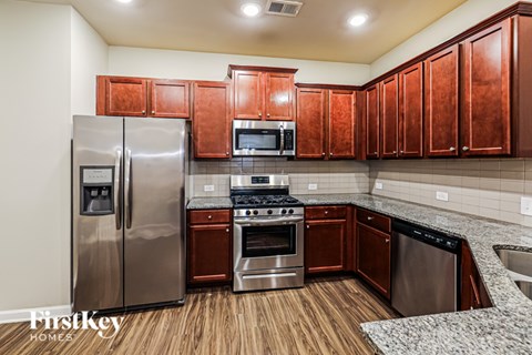 A kitchen with wooden cabinets and stainless steel appliances.
