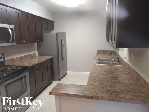a kitchen with granite counter tops and stainless steel appliances