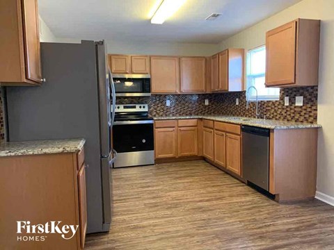 a kitchen with wooden cabinets and stainless steel appliances